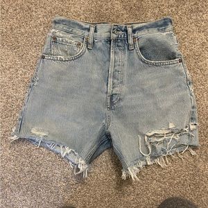 AGOLDE "Parker" shorts in distressed light-wash denim.
Mid-rise waist.